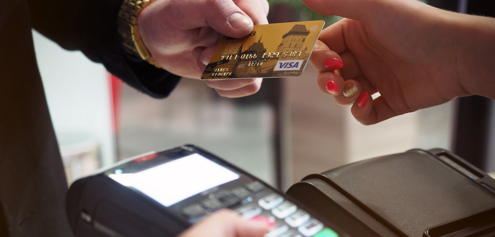 Photograph of man making payment using visa card