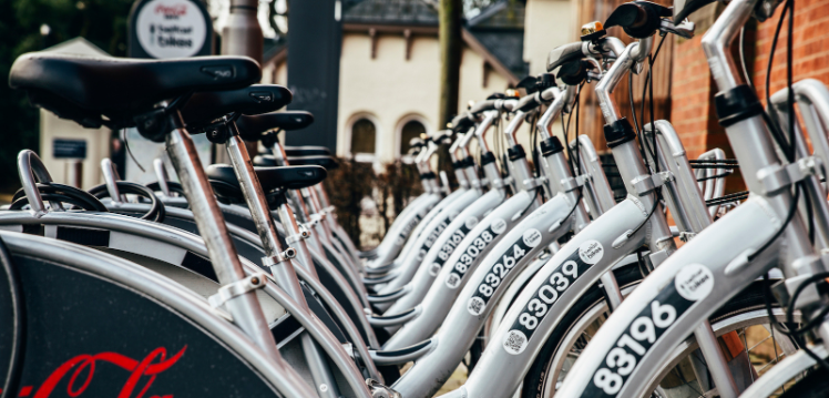 A row of silver Belfast bikes on campus