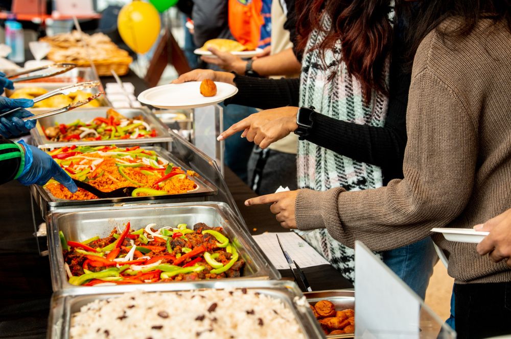 students being served Afro-Caribbean food