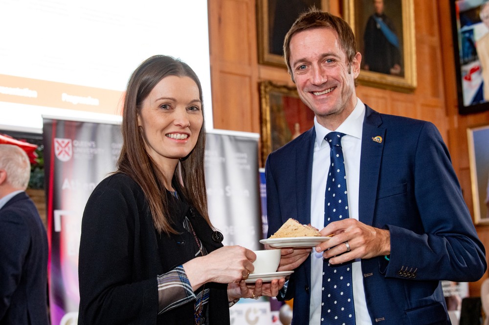 Professor Karen McCloskey and Conor Curran smiling with coffee and sanwiches