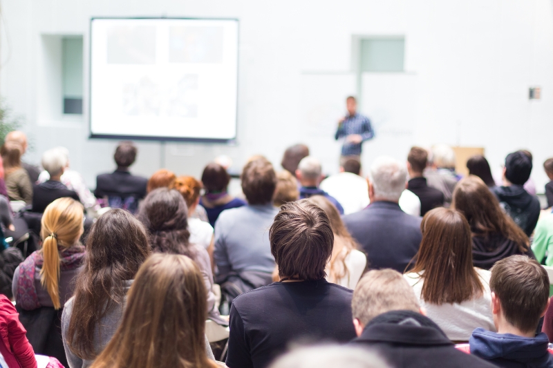 seated group of people listening in a large workshop