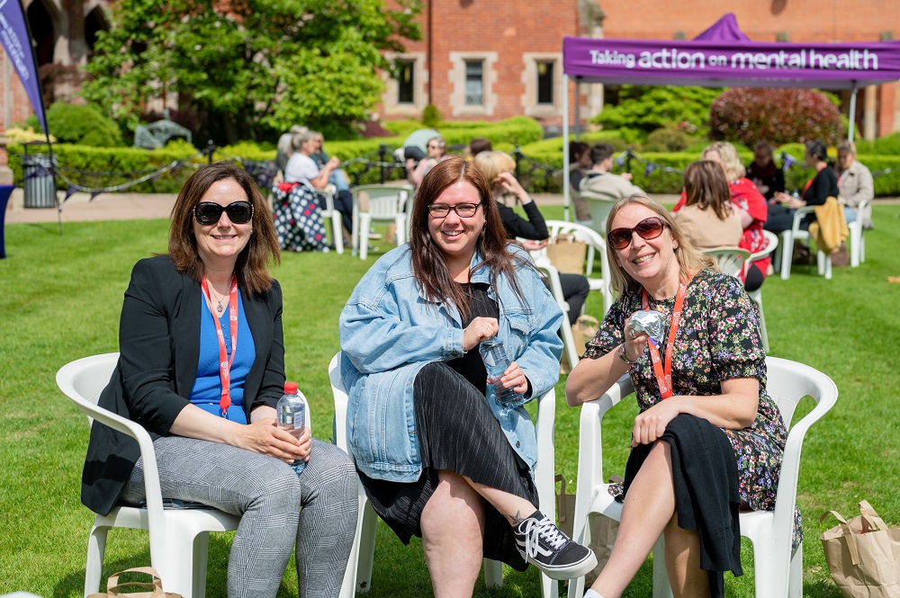 staff enjoying the sunshine and chat at the Great Big Purple Picnic in the quad during Mental Health Awareness Week 2023