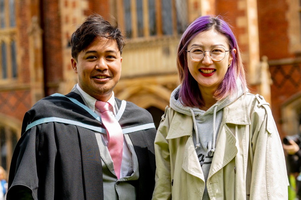 male International graduate and friend at summer graduations