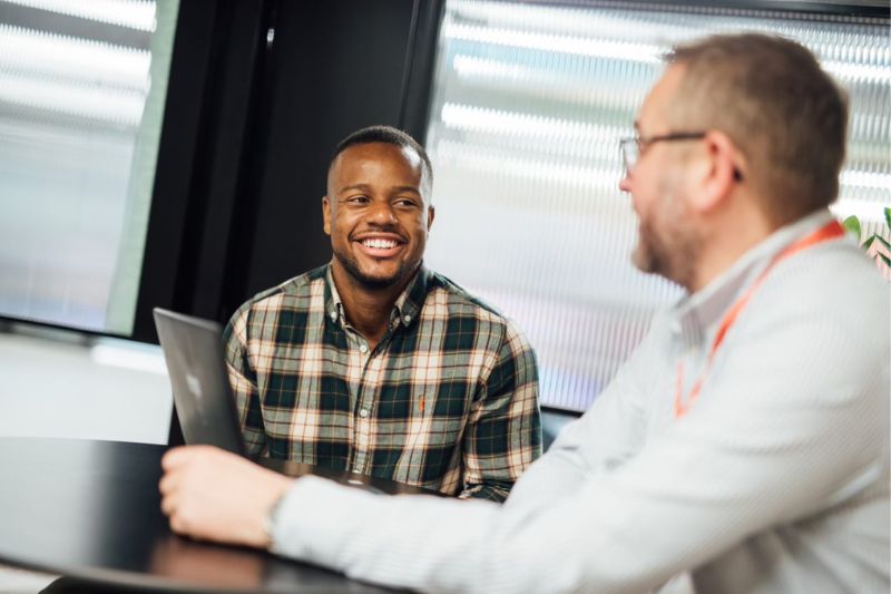 male student siting chatting to male careers consultant