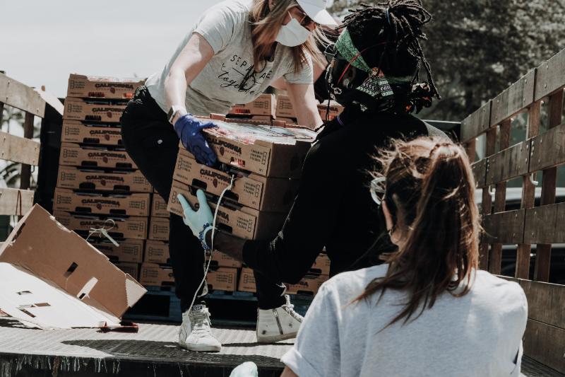 volunteers helping to carry supplies