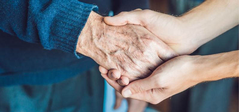 Two sets of hands holding, one old, one young