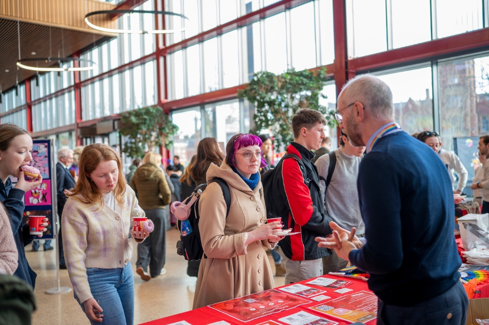 attendees of LGBTQueen's Celebration Showcase chatting to stall-holders