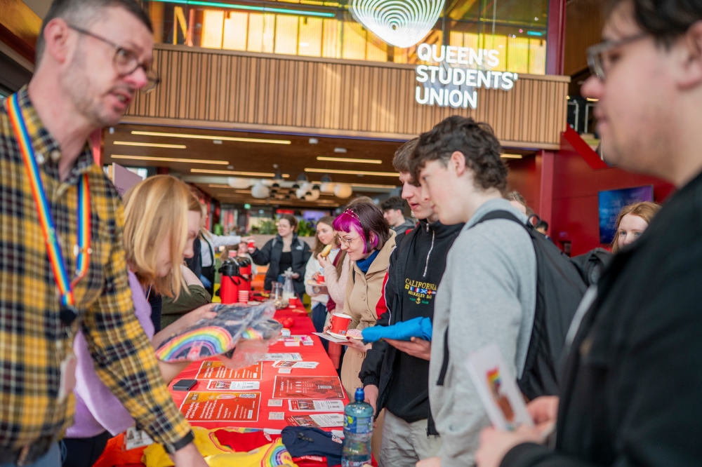 attendees of LGBTQueen's Celebration Showcase chatting to stall-holders