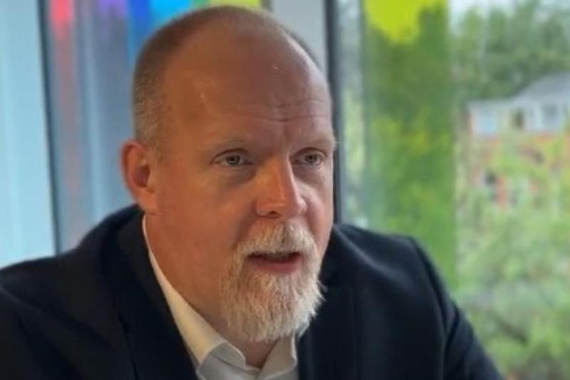 seated male academic chatting to someone off-camera