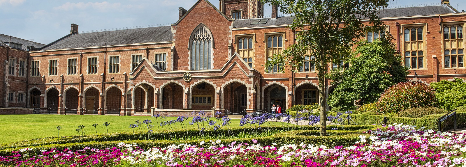 Queen's University Belfast quadrangle with summer flowers in foreground, July 2024