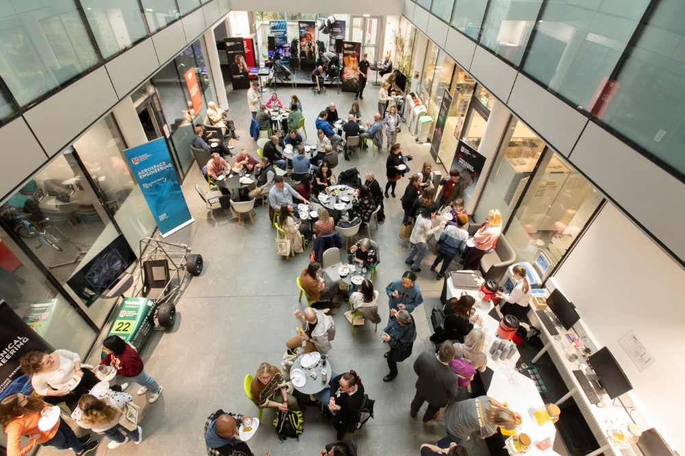aerial view of the entrance auditorium, School of Biological Sciences, Queen's University Belfast, showing facilitators and attendees of the Technician Showcase 2024